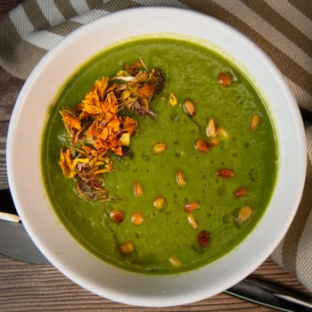 RECIPE FOR LEEK AND POTATO SOUP WITH GOLDEN PINE NUTS AND DRIED FLOWERS, High quality photo