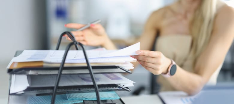 Close-up of female busy with papers on workplace, documents and problem projects, day in hurry. Clever company worker in office. Business, success concept