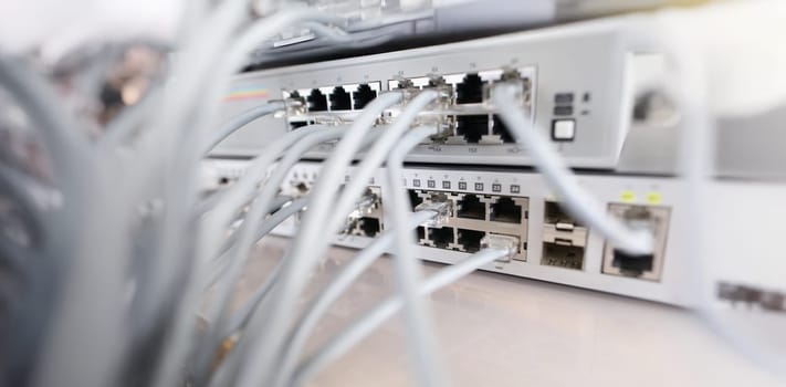 Close-up of set of cable network connected to internet switch servers in center. Control panel with wiring, electrical circuits. Provide internet concept