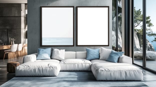 Two empty frames are providing copy space on a grey wall in a modern living room overlooking the ocean. The room is furnished with a white sectional sofa and blue pillows