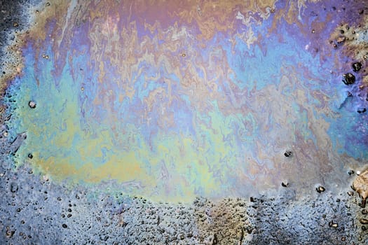 Abstract Oil Slick on Asphalt with Rainbow Colors.