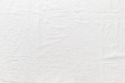 Fine bright linen cloth. The tablecloth on top view. Background for wedding and birthday celebrations in natural style with space for text