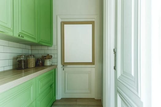 Interior of a bright kitchen featuring green cabinets, white subway tile, and wood countertops. A mockup frame hangs above a white door