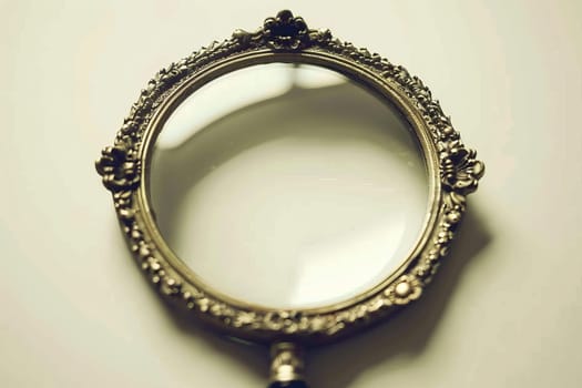 Close up view of a magnifying glass resting on a clean white surface for enhanced clarity