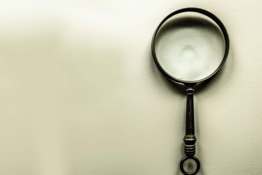 Close up of a magnifying glass isolated on a clean white background for clarity and focus