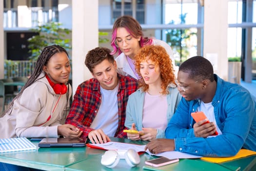 Multiracial college assignments and learning classes studying sitting around the university campus.