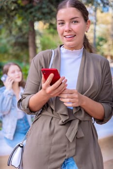 Caucasian woman hands typing on phone browsing telephone on social media outdoors