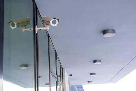 Camera system guarding office building with white housetop in horizontal format
