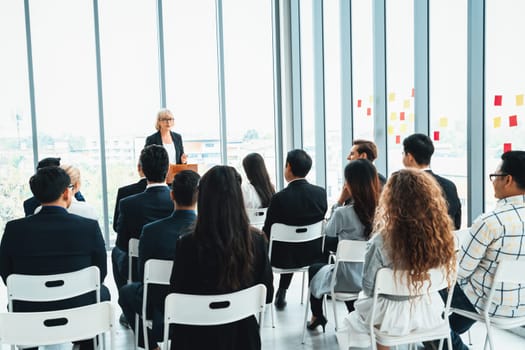 Group of business people meeting in a seminar conference . Audience listening to instructor in employee education training session . Office worker community summit forum with expert speaker . Jivy