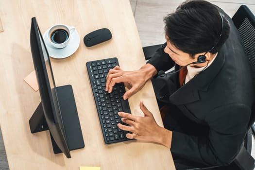 Business people wearing headset shot from top view in office working with computer. Jivy