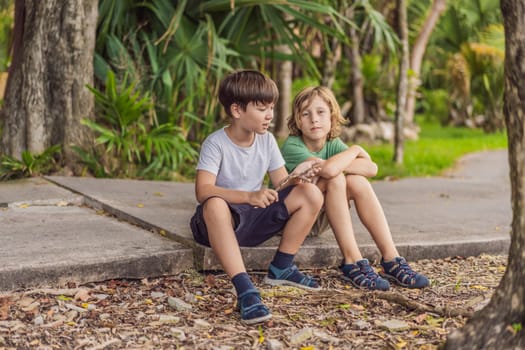 Two young boys share laughter and adventures in the sunlit park, cherishing the bonds of friendship and carefree moments.