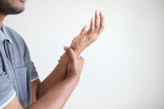 man suffering pain in hand close up .