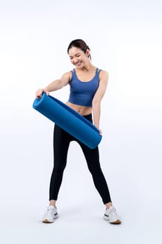 Young attractive asian woman portrait in sportswear with exercising mat. Healthy exercise and workout routine lifestyle concept. Studio shot isolated background. Vigorous