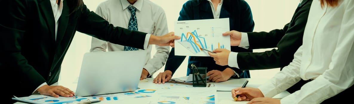 Business people in group meeting in formal attire share idea discussing report for company profit in creative workspace for start up business shot in close up view on group meeting table . Oratory .