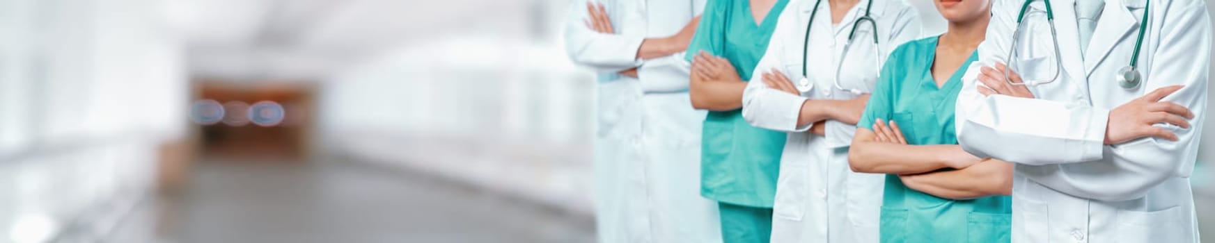 Confident medical staff team with doctor nurse and healthcare specialist professions people in blurry hospital corridor background. Medical and healthcare community in panoramic banner. Neoteric