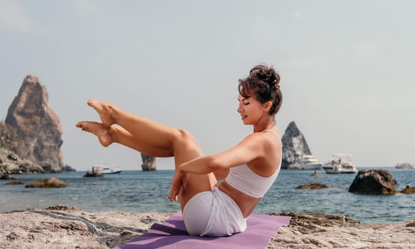 Fitness woman sea. Outdoor workout on yoga mat in park near to ocean beach. Female fitness pilates yoga routine concept. Healthy lifestyle. Happy fit woman exercising with rubber band in park.