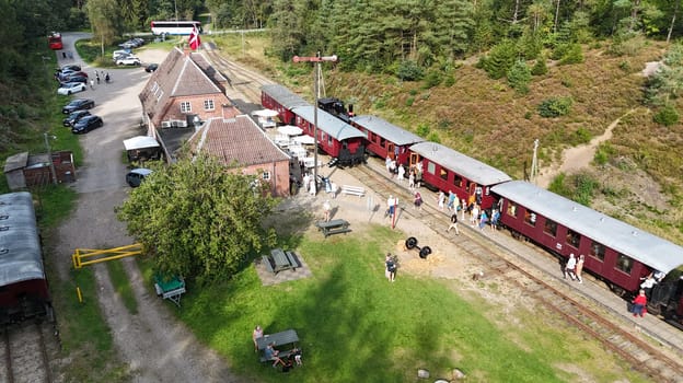 Vrads,denmark,08-09-2024:people at the train station waiting for the steam train from Vrads to Bryrup in denmark