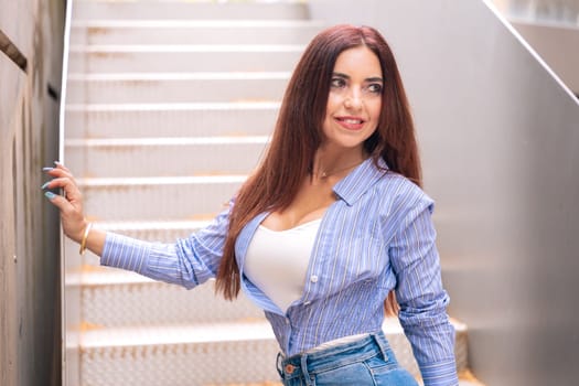 woman standing on stairs smiling posing for camera