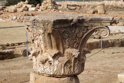 carved stone top of an ancient temple column in the Historical Park in Paphos, Cyprus.