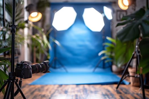 Studio photography setup with camera, lighting, tripod, background, and professional equipment