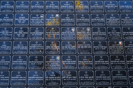 Tombstones of deceased Vietnamese near Christ the King Cathedral or Nha Trang Cathedral or Stone Church in Asia. Nha Trang, Vietnam - August 22, 2024