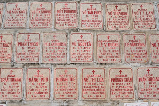 Tombstones of deceased Vietnamese near the Christ the King Cathedral also called Nha Trang Cathedral or Stone Church in Asia. Nha Trang, Vietnam - August 22, 2024
