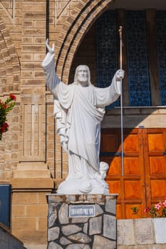 Sculpture of Jesus Christ in the square of Nha Trang Cathedral or Stone Church or Christ the King Cathedral in Asia. Nha Trang, Vietnam - August 22, 2024