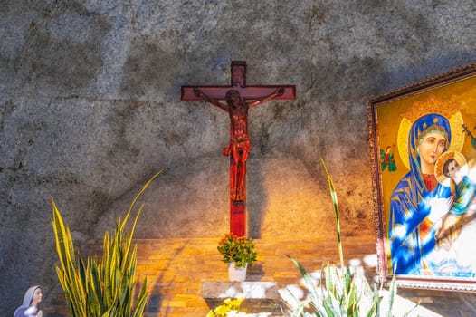 Wooden cross crucifixion with Jesus Christ God in a Catholic Cathedral