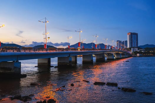 Tran Phu Bridge over the Cai River in Nha Trang at summer evening. Panorama of Nha Trang city in Vietnam