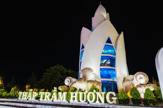 Landmark white Lotus Tower or Thap Tram Huong Tower in Nha Trang city on the waterfront at night in Vietnam
