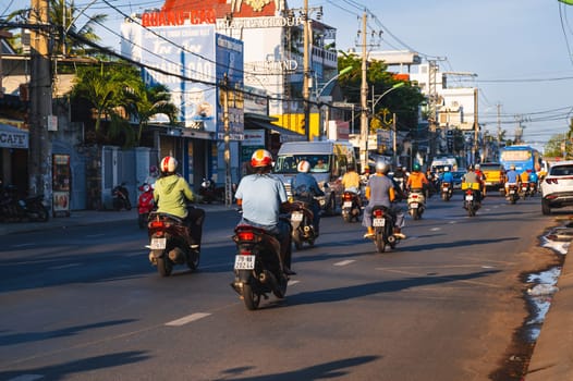 Motorbike traffic on the road in a city in Asia in the summer in day. Nha Trang, Vietnam - August 22, 2024