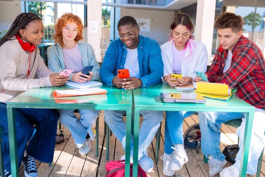 group of five happy students are studying outdoors at university, using smartphones. They're engaged, collaborating, and enjoying their learning experience in a modern, tech-friendly environment