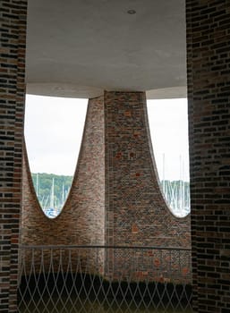 The iconic Fjordenhus between two houses in the harbour basin of Vejle, Denmark, view from insite to outdoor