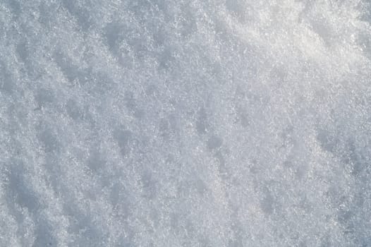 white texture of snow on a snowdrift on a cold winter day
