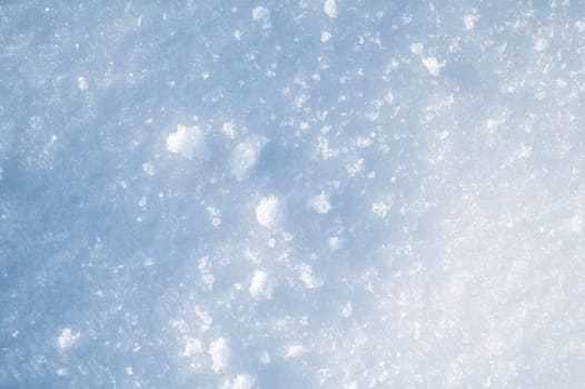 background with a texture of white blue snow on a snowdrift on a cold sunny winter day