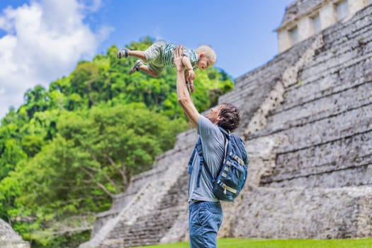 Mother with his toddler son exploring the ancient pyramids of Palenque, Mexico, surrounded by dense jungle. Cultural heritage and adventure travel concept.