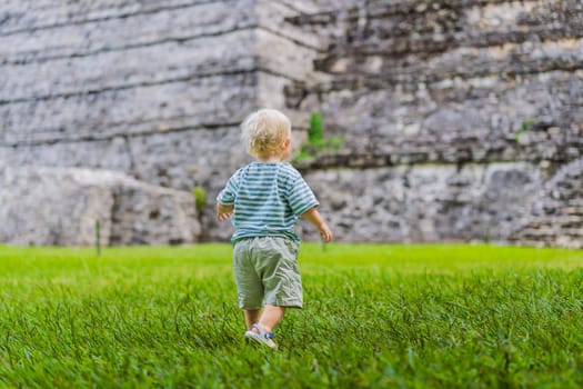 Baby tourist exploring the ancient pyramids of Palenque, Mexico, surrounded by dense jungle. Cultural heritage and adventure travel concept.