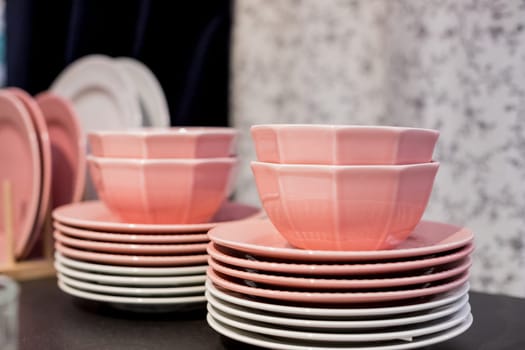 Commercial white plates and bowls stacked with crystal wine glasses