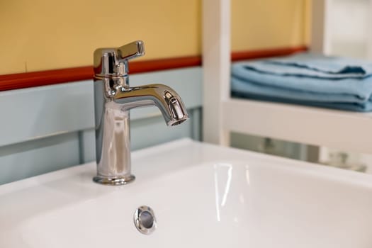 Bathroom interior with white sink and faucet.Water tap