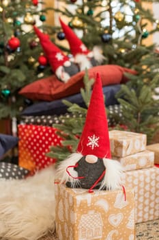 Christmas gnome decor with santa hat. Holiday bohek background.