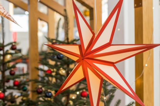 A Christmas star in the window. Warm light, Christmas, cosy atmosphere.