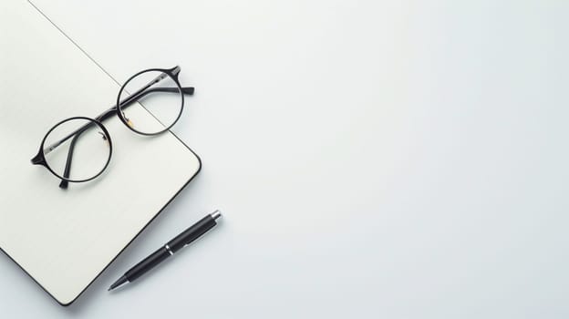 A minimalist workspace features a blank notebook and a sleek pen next to a pair of glasses, inviting creativity and reflection. The arrangement highlights simplicity and focus, perfect for writing or sketching ideas. Natural light enhances the serene atmosphere, fostering a productive environment.