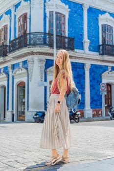 Female tourist in front of Casa de los Azulejos in Villahermosa, Mexico. Quintana Roo travel, cultural exploration, and historic architecture concept.