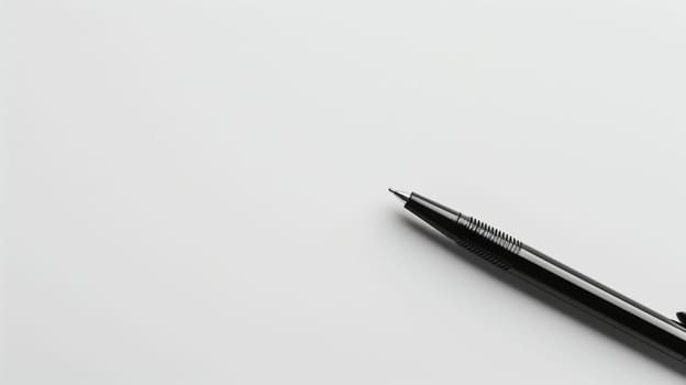 A sleek black ink pen is positioned diagonally across a pristine white background, showcasing its refined design. The pen's smooth surface reflects light, highlighting its shape and details. This arrangement emphasizes the minimalist aesthetic of office supplies.