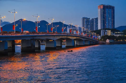 Tran Phu Bridge over the Cai River in Nha Trang at night. Panorama of Nha Trang city in Vietnam