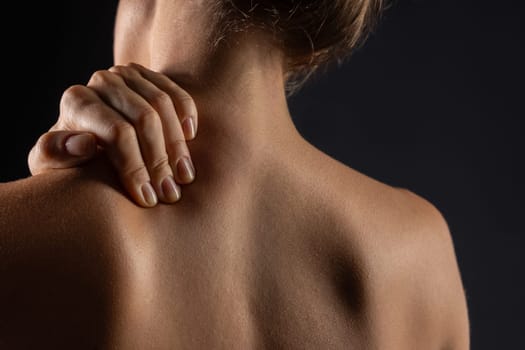 woman massaging neck close-up, concept of neck pain with osteochondrosis protrusion and hernia in the cervical spine,