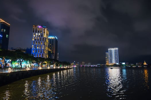 Da Nang city with a Han River Bridge over the Han river and skyscrapers hotels in Vietnam at night