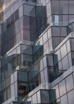 Bangkok, Thailand - 28 Sep, 2024 - Architecture exterior of Modern building with many glass wall reflecting with the sky background at afternoon. Space for text, Selective focus.