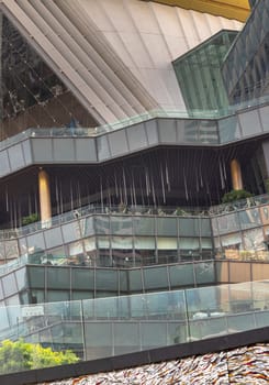 Bangkok, Thailand - 28 Sep, 2024 - Architecture exterior of Iconsiam shopping mall with A steel frame glazed with many glass wall reflecting with the sky background at afternoon. Space for text, Selective focus.