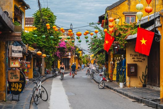 Streets with traditional ancient yellow houses in the old town in Hoi An city in Vietnam at day. Hoi An, Vietnam - September 12, 2024